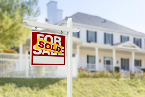 For sale sold sign in front of house